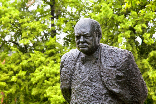 Winston Churchill statue against a background of trees