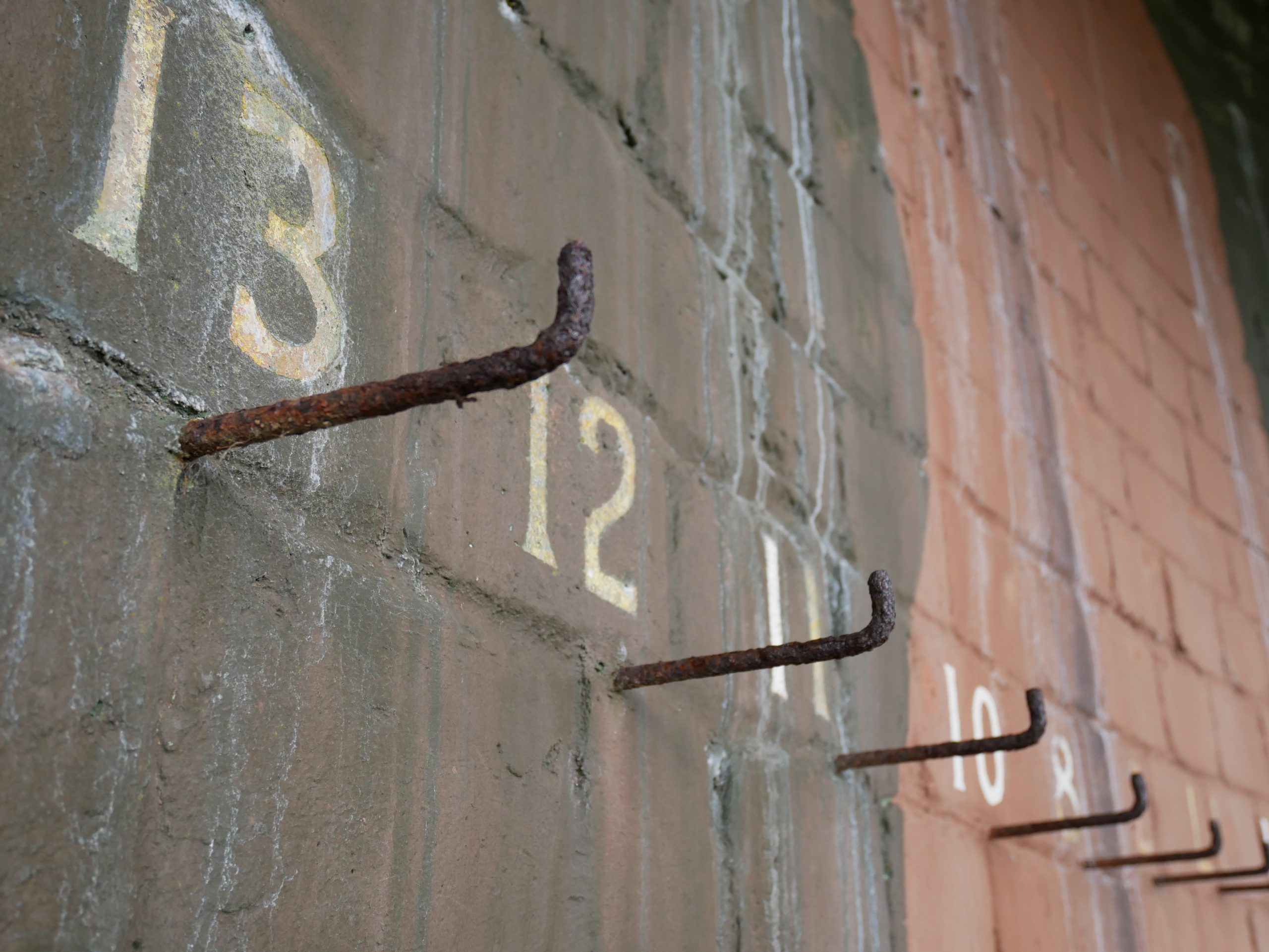Pegs in a Military Barracks, ending in the number 13