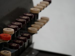An artistic photo of the keys of an old-fashioned shop till/cash register